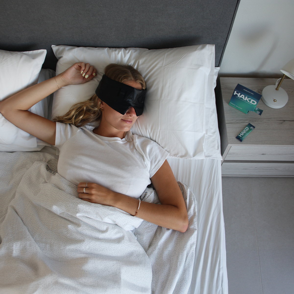 Person resting in bed wearing a sleep mask