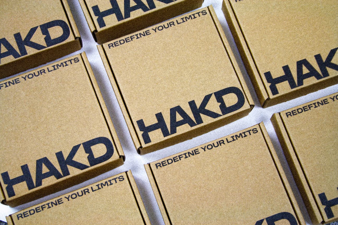 HAKD Health branded shipping boxes with ‘Redefine Your Limits’ slogan, packaging for natural sleep supplements and wellness products