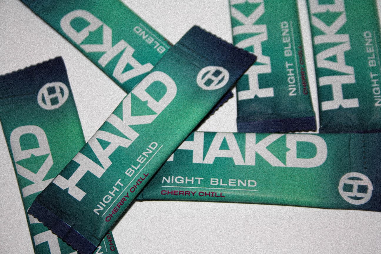 Multiple sachets of HAKD Health Night Blend Cherry Chill, a natural sleep supplement formulated to support deep sleep and nighttime relaxation.