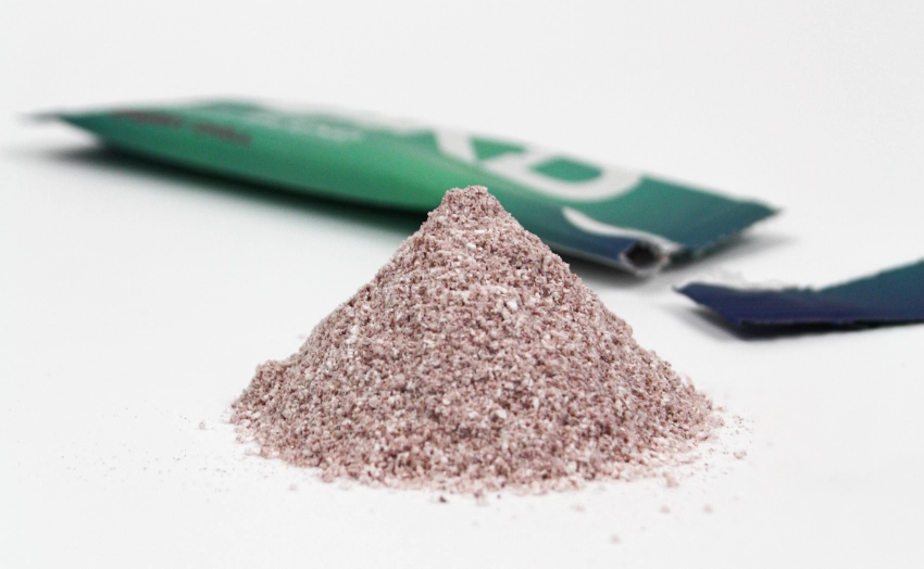 Close-up of HAKD Night Blend cherry-flavoured powder sachet opened, showcasing the fine natural blend of sleep-supporting ingredients