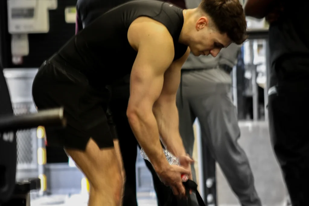 Man training in a gym, demonstrating strength, conditioning, and high-intensity fitness work.