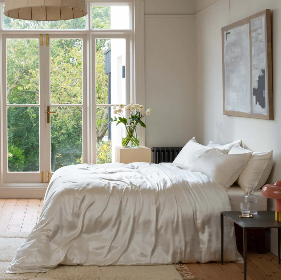 Luxury silk bedding for temperature-regulated, comfortable sleep in a calming bedroom setting